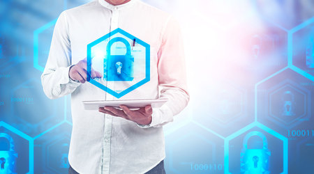 Man in white shirt using tablet computer with double exposure of online security interface. Concept...