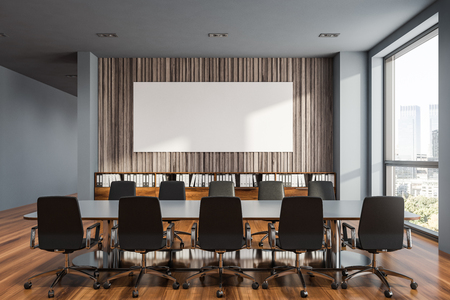 Interior of modern meeting room with gray and wooden walls, wooden floor, long gray table with black chairs and folders on bookshelves. Horizontal mock up poster. 3d renderingの写真素材