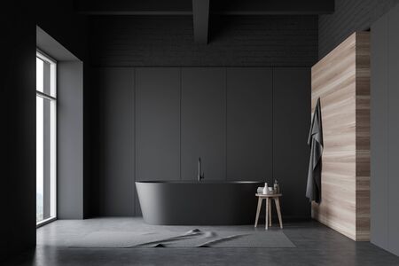 Interior of stylish bathroom with gray, brick and wooden walls, concrete floor, large window, comfortable gray bathtub and carpet on the floor. 3d renderingの写真素材