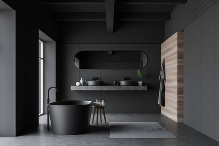 Interior of stylish bathroom with gray, brick and wooden walls, double sink with long mirror standing on gray shelf and comfortable gray bathtub. 3d renderingの写真素材