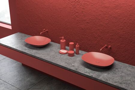 Corner of modern bathroom with red walls and red double sink standing on stone countertop with soap and bathroom accessories. Concrete floor and loft window. 3d renderingの写真素材