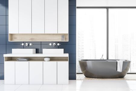 Interior of panoramic bathroom with blue tile walls, white tile floor, double sink on white...