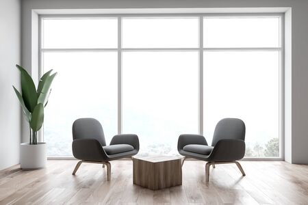 Interior of stylish office waiting room with white walls, wooden floor, large window, two gray...