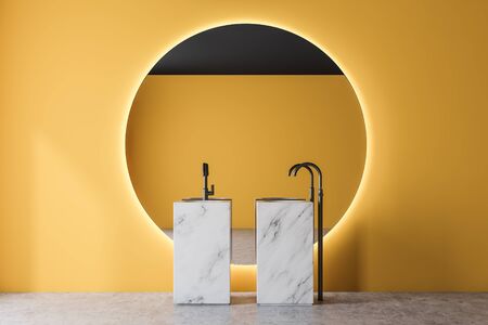 Interior of modern bathroom with yellow walls, concrete floor, marble double sink and large round mirror. 3d renderingの写真素材