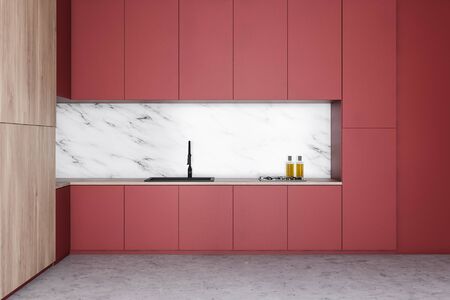 Interior of stylish kitchen with white marble and wooden walls, concrete floor and red countertops with built in sink and cooker. 3d renderingの写真素材