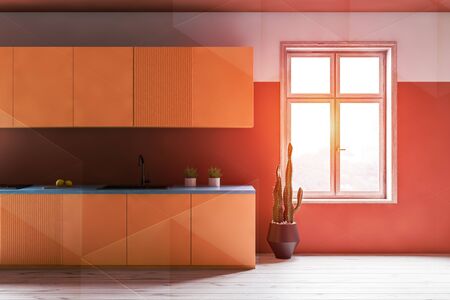 Interior of comfortable kitchen with white and orange walls, wooden floor, large window, yellow...