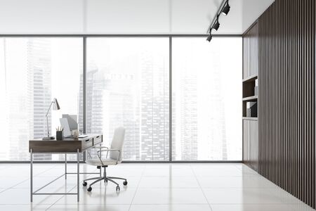 Side view of empty CEO office with wooden walls, tiled floor, panoramic window, wooden computer desk and bookcases with folders. Concept of leadership. 3d renderingの写真素材