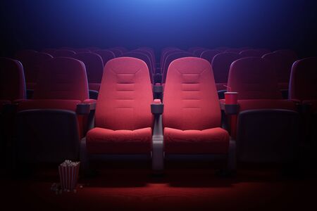 Interior of empty cinema with rows of red seats with cup holders and popcorn. Concept of entertainment. 3d rendering toned imageの写真素材