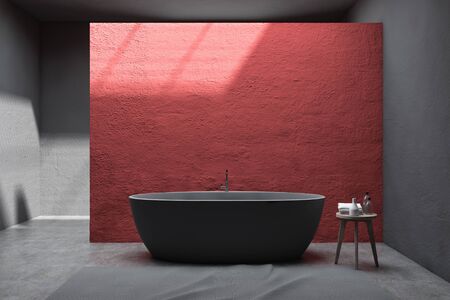 Interior of stylish bathroom with red and gray walls, concrete floor, comfortable gray bathtub and chair with towels and bottles. 3d renderingの写真素材