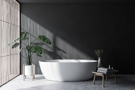 Interior of minimalistic bathroom with gray walls, concrete floor, light wooden blinds, comfortable...