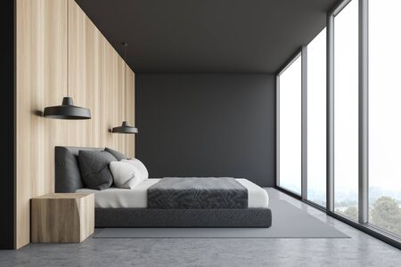 Side view of panoramic bedroom with gray and wooden walls, concrete floor with carpet, king size bed and window with magnificent scenery. 3d renderingの写真素材