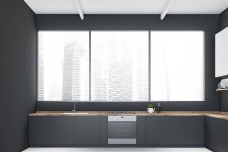 Interior of minimalistic kitchen with gray walls, concrete floor, panoramic window with cityscape, grey countertops and white cupboards. 3d renderingの写真素材