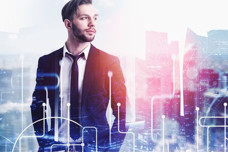 Confident caucasian businessman with beard standing with hands in pockets in modern city white...