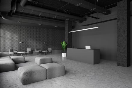 Corner of spacious industrial style office with dark gray walls, concrete floor, reception desk with laptops and waiting room with armchairs, poufs and coffee tables. 3d renderingの写真素材