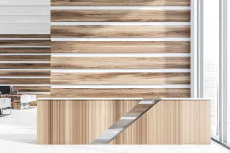 Wooden reception desk standing in modern office lobby with wooden walls and open space area with computer tables in background. 3d renderingの写真素材