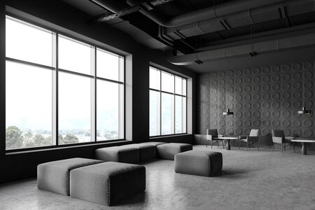 Corner of modern industrial style office lounge area with dark gray walls, concrete floor, grey armchairs near coffee tables and windows with mountain view. 3d renderingの写真素材