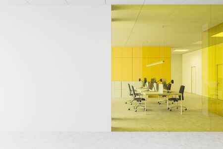 Interior of open space office with white and yellow glass walls, concrete floor, long computer tables with black chairs and mock up wall. 3d renderingの写真素材