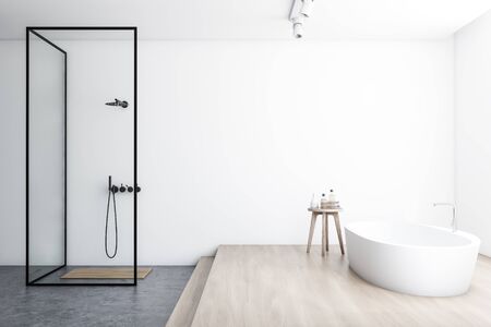 Side view of modern bathroom with white walls, concrete and wooden floor, comfortable white bathtub and walk in shower with glass walls. 3d renderingの写真素材
