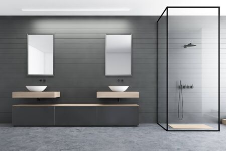 Interior of modern bathroom with gray walls, concrete floor, double sink with mirrors, gray cabinet and shower with glass walls. 3d renderingの写真素材