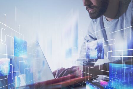 Bearded young man in casual clothes using laptop with double exposure of social media and internet...