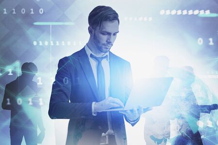 Handsome beared young businessman with clipboard working over blurred background with double exposure of network interface. Concept of fintech and coding. Toned imageの写真素材