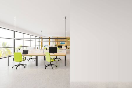 Interior of bright open space office with wooden walls, panoramic windows with tropical view, rows of computer tables with green chairs and mock up wall to the right. 3d renderingの写真素材