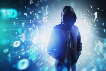 Unrecognizable young hacker in black hoodie and jeans standing over blurry futuristic binary numbers...