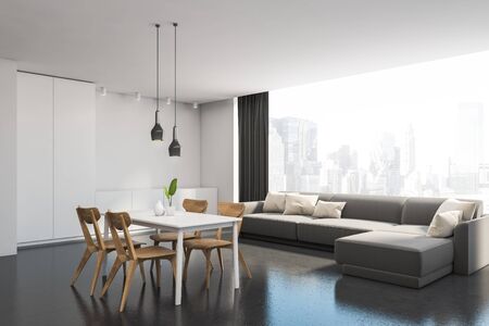 Corner of comfortable modern dining room with white walls, concrete floor, comfortable gray sofa...