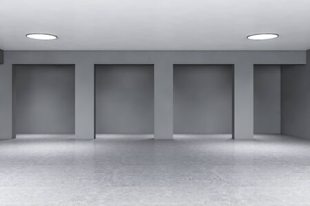 Interior of empty office building in industrial style with gray walls with columns, concrete floor...