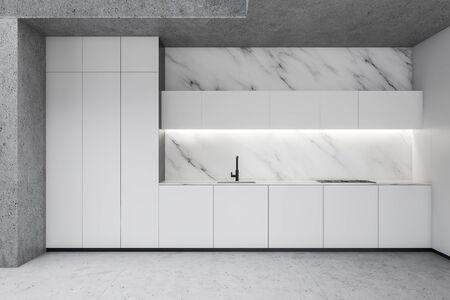 Interior of luxury minimalistic kitchen with white marble and concrete walls, stone floor, white cupboards and countertops with built in stove and sink. 3d renderingの写真素材