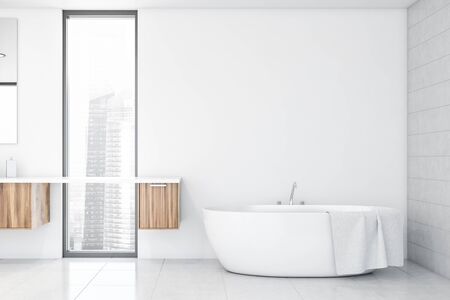 Interior of modern bathroom with white and tiled walls, tiled floor, comfortable bathtub standing in...
