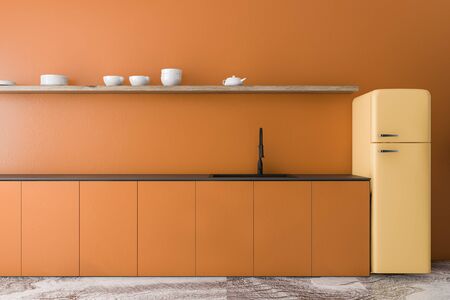 Interior of stylish minimalistic kitchen with orange walls, marble floor, orange countertops with built in sink, shelf with dishes and bright yellow fridge. 3d renderingの写真素材