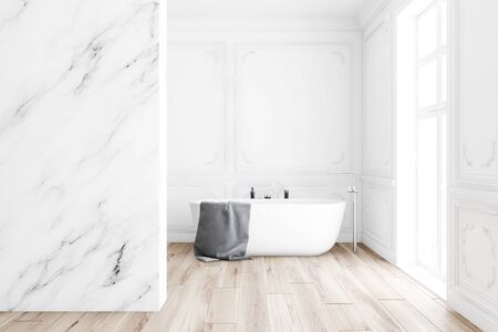 Interior of classic style bathroom with white marble walls, wooden floor, comfortable bathtub with gray towel on it and big window. 3d renderingの写真素材