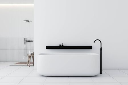 Interior of stylish bathroom with white and tiled walls, white tiled floor, comfortable bathtub with black shelf above it and shower stall with glass walls. 3d renderingの写真素材