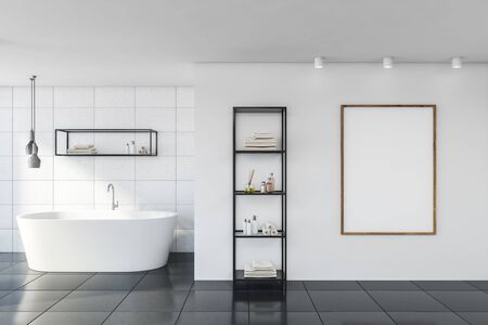 Interior of stylish bathroom with white tile walls, gray floor, comfortable bathtub, vertical mock up poster and shelves with beauty products. 3d renderingの写真素材
