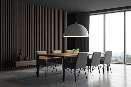 Corner of stylish dining room with gray and dark wooden walls, concrete floor, panoramic window, long table with comfortable chairs and massive lamp. 3d renderingの写真素材
