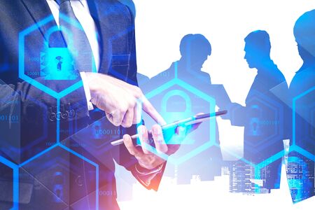Close up of businessman using tablet computer in city with double exposure of blurry cyber security interface and business people silhouettes. Concept of data protection in business. Toned imageの写真素材