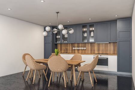 Corner of stylish kitchen with white and wooden walls, concrete floor, white countertops, grey cupboards and wooden dining table with beige chairs. 3d renderingの写真素材