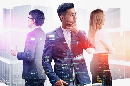 Diverse successful team of managers in modern city with double exposure of skyscrapers. Concept of teamwork and international partnership. Toned imageの写真素材