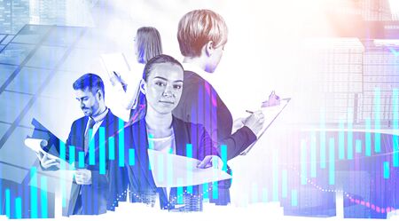 Young business people with documents standing in abstract city with double exposure of charts. Concept of paperwork and business education. Toned imageの写真素材