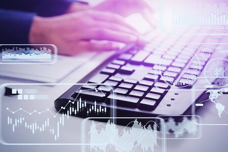 Blurry hands of businessman typing on keyboard in office with double exposure of infographics...