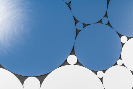 Abstract pattern made of blue and white circles of different sizes over dark gray background. Concept of art and creativity. 3d renderingの写真素材