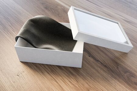 Open white gift box with gray rug lying on wooden table. Concept of holidays and celebration. 3d...