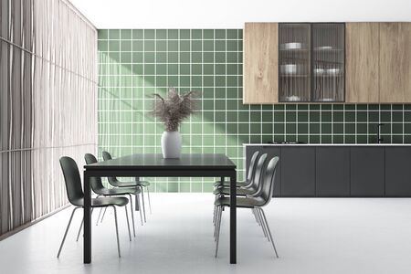 Interior of stylish kitchen and dining room with green tiled walls, white floor, grey countertops, wooden cupboards and long table with gray chairs. 3d renderingの写真素材