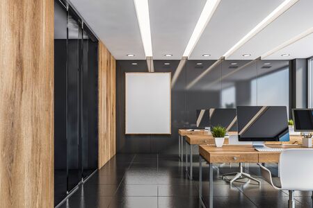 Interior of modern open space office with gray panel and wooden walls, row of wooden computer desks...