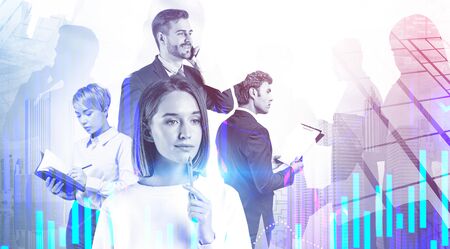 Diverse young business team with gadgets and documents working in city with double exposure of graphs. Concept of start up and teamwork. Toned imageの写真素材