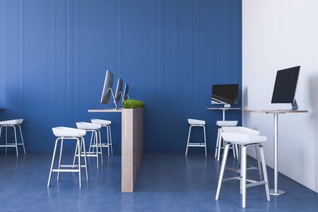 Interior of stylish open space office with blue and white walls, blue floor and wooden computer...
