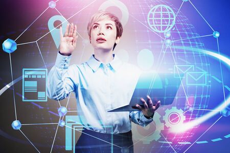 Asian woman computer engineer with laptop working with futuristic network interface. Concept of hi tech and big data. Toned image double exposureの写真素材