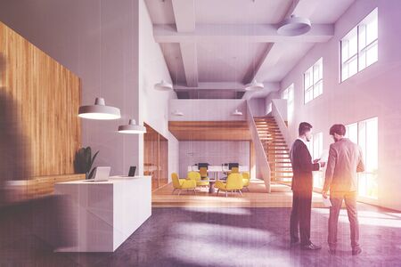 Blurry businessmen talking in stylish office with white and wooden walls, reception desk, waiting...