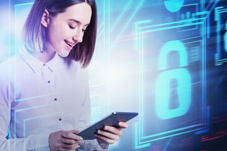 Cheerful young businesswoman working with tablet computer with double exposure of blurry cyber...